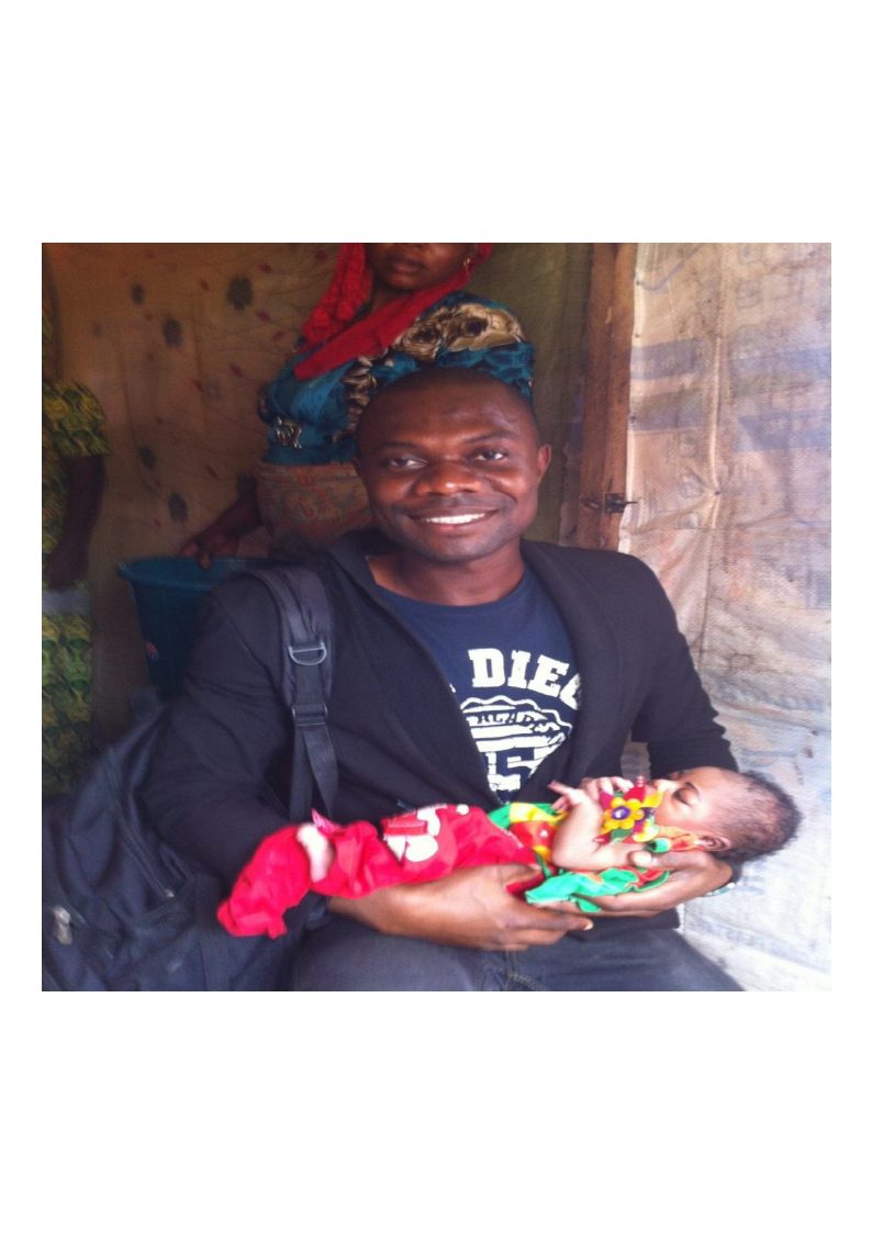 GHRC team member with a mother and infant in the field